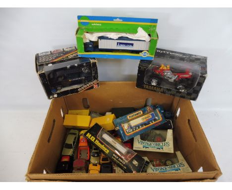 A box of assorted die-cast vehicles, differing makes and scales.