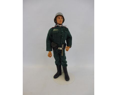 A circa 1970s Action Man, with blond flock hair, in a Colditz Castle German uniform.