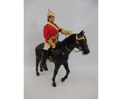 A circa 1970s Action Man household cavalry figure and horse, many accessories, reigns, sword in scabbard, helmet etc.