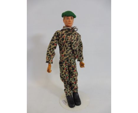 A circa 1970s Action Man figure, in a camouflage uniform.