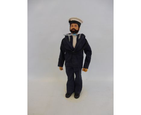 A 1970s Action Man with beard and black flock hair, in a British sailor's outfit.