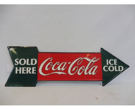 A Coca-Cola tin directional arrow dated 1990, 27 x 9".