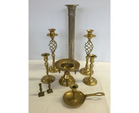 A box of brass candlesticks and one large white metal stick.