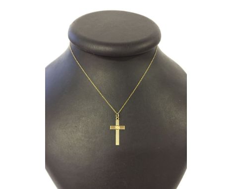 A hallmarked 9ct gold cross with a circle and engine turned engraved decoration. Approx 1" x 0.5" on a 16" trace chain.