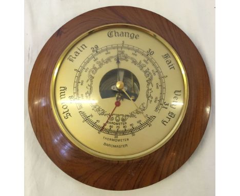 A round wall barometer.