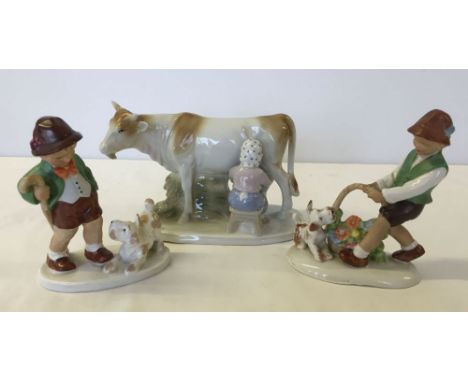 3 continental porcelain figures - 2 Hummel style boys and a cow & milkmaid.
