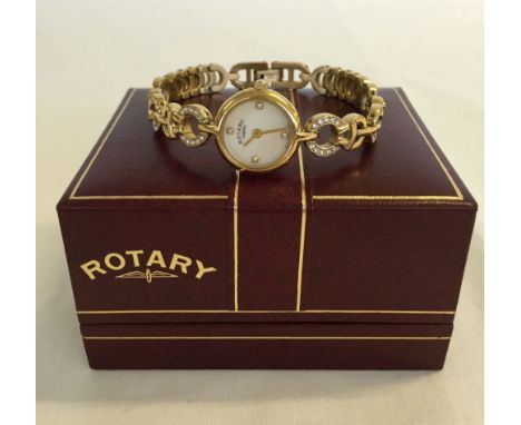 A boxed Rotary ladies watch set with diamante stones in strap. In working order.