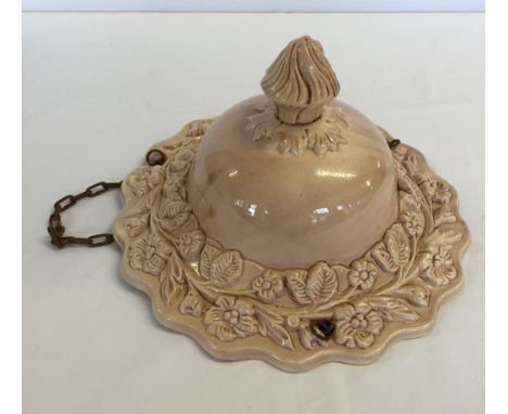 A vintage ceramic ceiling light shade.