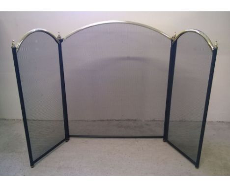 A modern metal fire screen.
