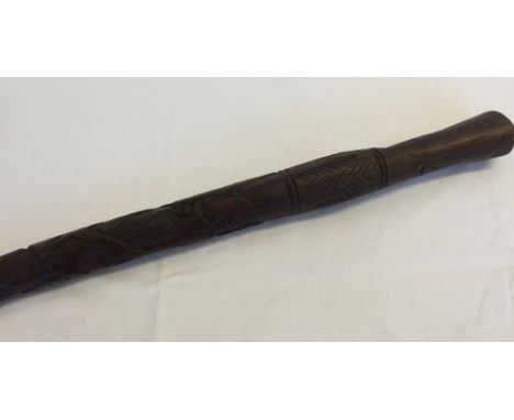 An african hard wood Tribal stick with carved decoration.