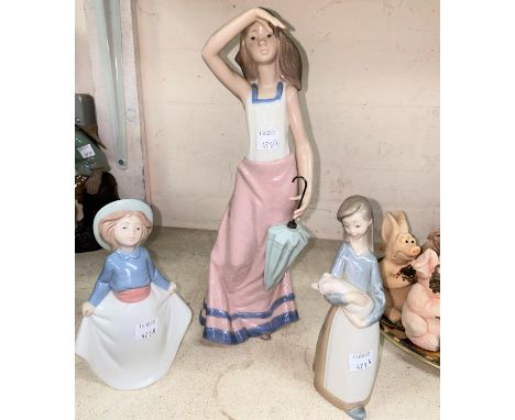A large Nao girl with umbrella; similar smaller Lladro and Nao figure of girls. 