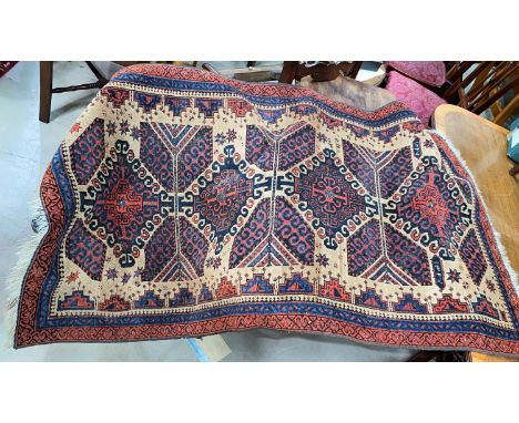 A small 20th century hand knotted carpet with rust ground, signed and dated 
