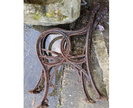 A large metal sash clamp; a Victorian pair of cast iron bench ends; a fender 