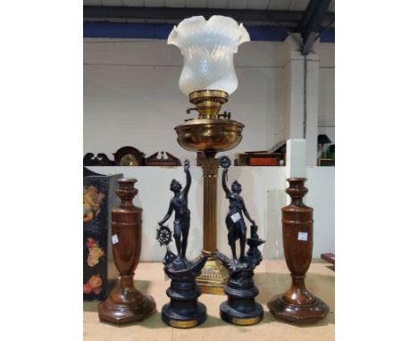 A Corinthian column reeded brass oil lamp with milk glass shade; a 19th century pair of spelter figures; a pair of turned woo