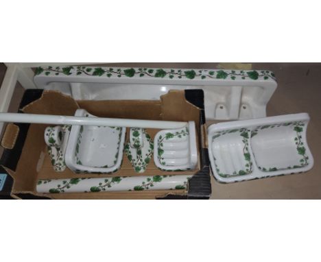 A suite of glazed stoneware bathroom furnishings to include shelf, 72cm, towel rail and soap dishes, vine pattern