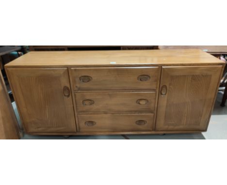 An Ercol light elm sideboard of 2 cupboards and 3 central drawers 