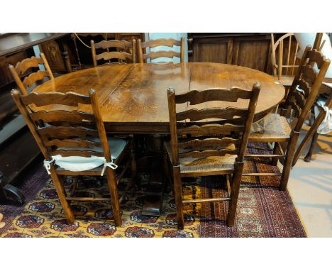 An oak circular, pedestal extending dining table with on spare leaf, in the Titchmarsh &amp; Goodwin manner, with heavily car