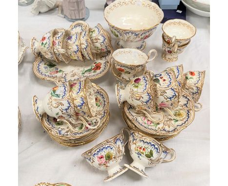 A mid 19th century 36 part tea set by H &amp; R Daniel, "Savoy" pattern with gilded 'C' scroll borders and hand painted polyc