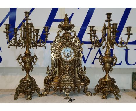 A large Rocco style three piece clock garniture central gilt metal clock and two matching 6 branch candelabra height 61cm 