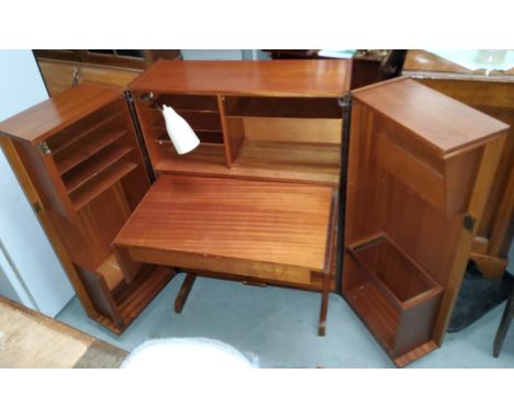 A mid 20th century teak 'magic desk' with fold out doors containing interior pull out writing surface with various compartmen