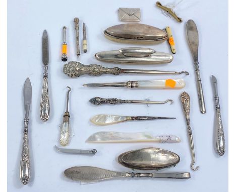 A hallmarked silver stamp case fob, 2 gem set Edwardian toothpicks, various nail buffers, button hooks etc. 