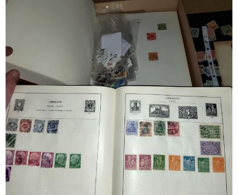 A Strand album with a vintage collection of stamps; a collection of world stamps 