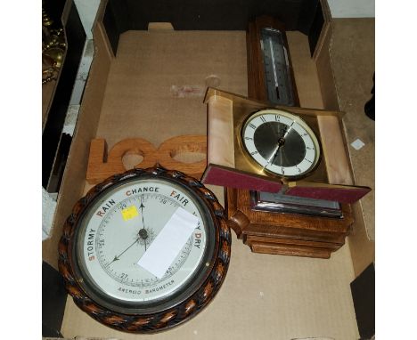 A circular oak rope twist barometer, another barometer and a battery clock 