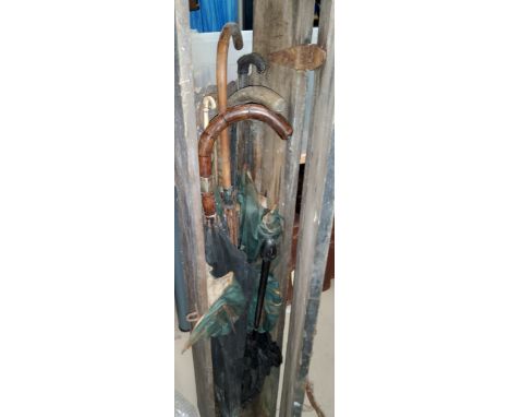 A quantity of vintage umbrella mechanisms; handles; etc. 