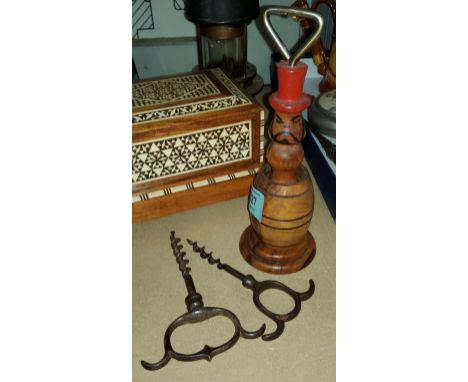 A novelty carved wooden bottle opener and two vintage corkscrews 