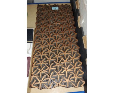 A vintage carved wood hand held printing block decorated with starfish shapes, 47x21cm 