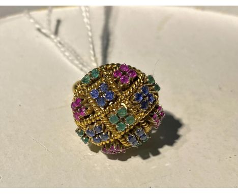 A lady's continental cocktail ring set groups of coloured stones in domed mount, marked '750', 12 gm gross weight, size K+ 