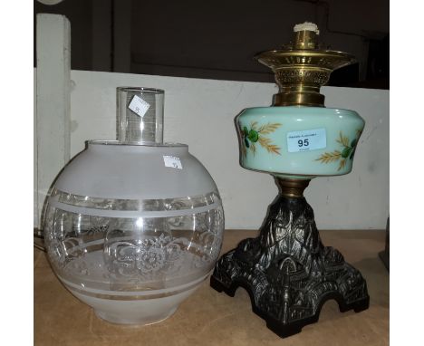 A Victorian cast iron oil lamp with turquoise floral reservoir, chimney and shade 
