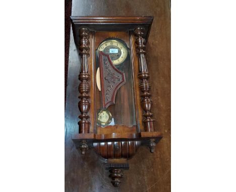 A 19th century Vienna style wall clock, key wound, in walnut case 