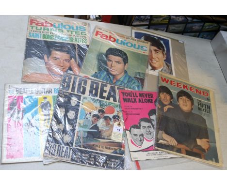 A quantity of Rock music memorabilia, mostly Beatles related. Including vintage publications, articles in contemporary magazi