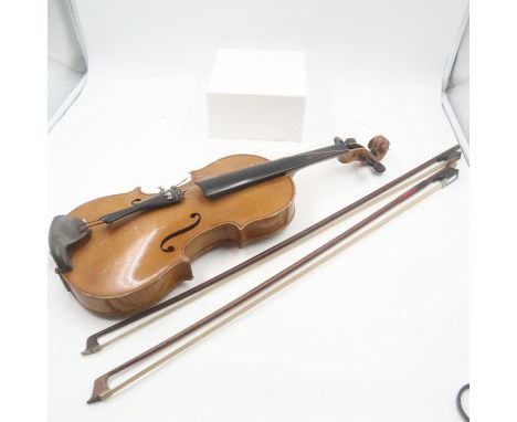 Czechoslovakian made copy of Antonius Stradivarius violin with two bows. Is in need of repair and restoration, damage to wood