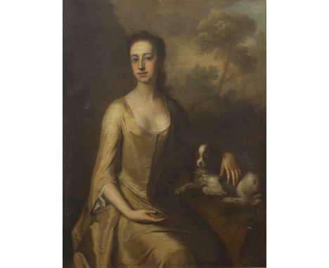 Follower of Charles Jervas (Dublin circa 1675-1739 London)Portrait of a lady, seated three-quarter-length, with a spaniel at 
