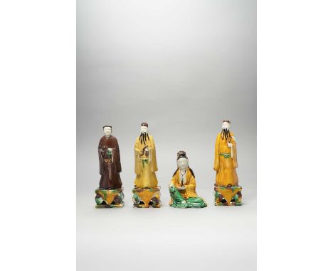 FOUR CHINESE EGG AND SPINACH-GLAZED FIGURESKANGXI 1662-1722Three standing on rectangular plinths, the fourth a seated figure 