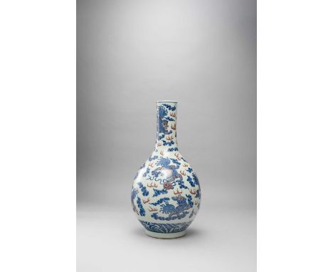 A LARGE CHINESE BLUE AND WHITE AND UNDERGLAZED-RED BOTTLE VASE PROBABLY LATE QING DYNASTYDecorated with nine qilin playing wi