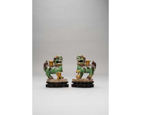 A PAIR OF CHINESE FAMILLE VERTE LION DOGS KANGXI 1662-1722The male with a reticulated brocade ball, the female with her puppy