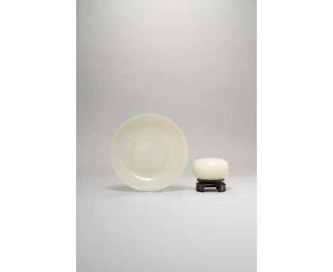 A CHINESE PALE CELADON JADE DISH AND A BOX AND COVERQIANLONG/JIANQIANGEach raised on a short circular foot, the dish with sha