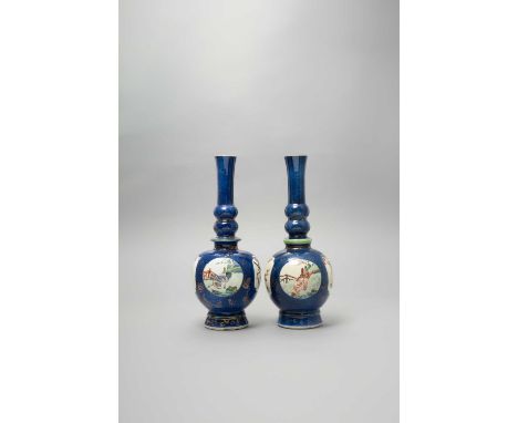 A NEAR PAIR OF CHINESE FAMILLE VERTE POWDER-BLUE GROUND BOTTLE VASESKANGXI 1662-1722Each painted with four panels containing 