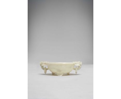 A LARGE CHINESE PALE CELADON JADE TWO-HANDLED BOWL QING DYNASTY OR LATERThe interior carved in relief with large sprays of li