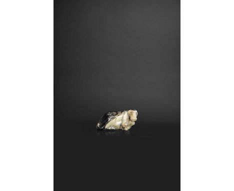 A CHINESE BLACK AND CELADON PEBBLE JADE CARVING OF A HORSEMING DYNASTYThe animal sits with its head turned and resting on the
