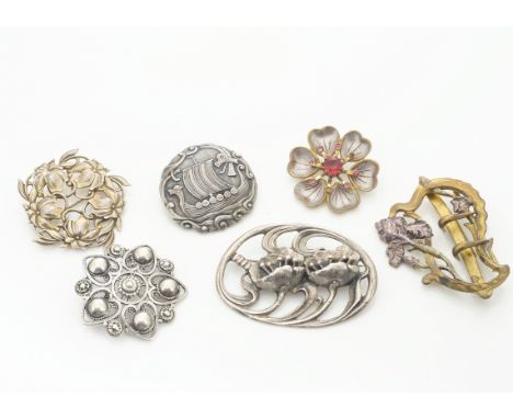A collection of Art Nouveau and Art Nouveau style brooches, including a Norwegian example of a Viking ship with dragon marked