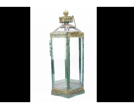 A large hexagonal metal painted candle lantern, in the Moroccan taste, the hexagonal shape with pierced metalware panels supp
