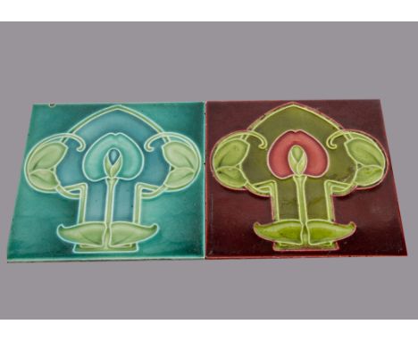 Two Godwin and Hewitt relief moulded Art Nouveau tiles, of similar stylised floral design, one in red the other in blue, 15cm