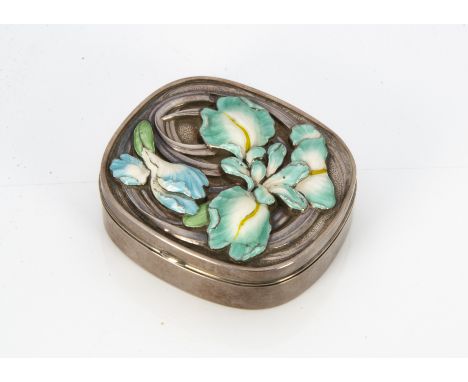 A white metal and enamel oval box, the hinged lid with embossed floral design of a lily in green and blue enamel heightened i