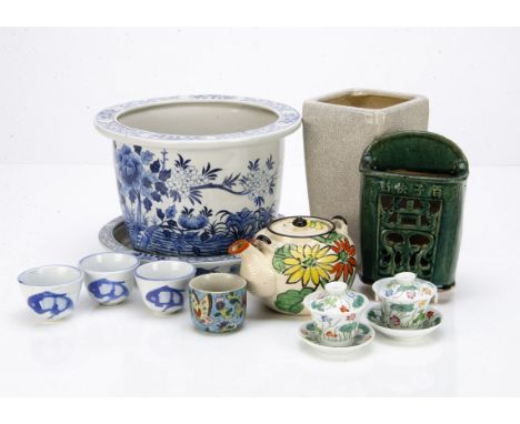 A pair of contemporary polychrome decorated tea bowls and covers, 5cm high, and saucers decorated with flower design, a conte