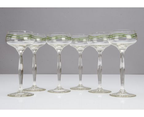 A set of six Art Nouveau German hock glasses, the colourless bowl and shaped stem decorated with two green enamel wavy bands 