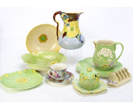 A collection of Art Deco Royal Winton Grimwades pottery, comprising two moulded jugs, one with white primroses and pansies ag